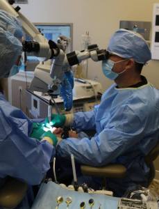 Photo of Raleigh NC Endodontist Dr. Tony using an operating microscope for surgery
